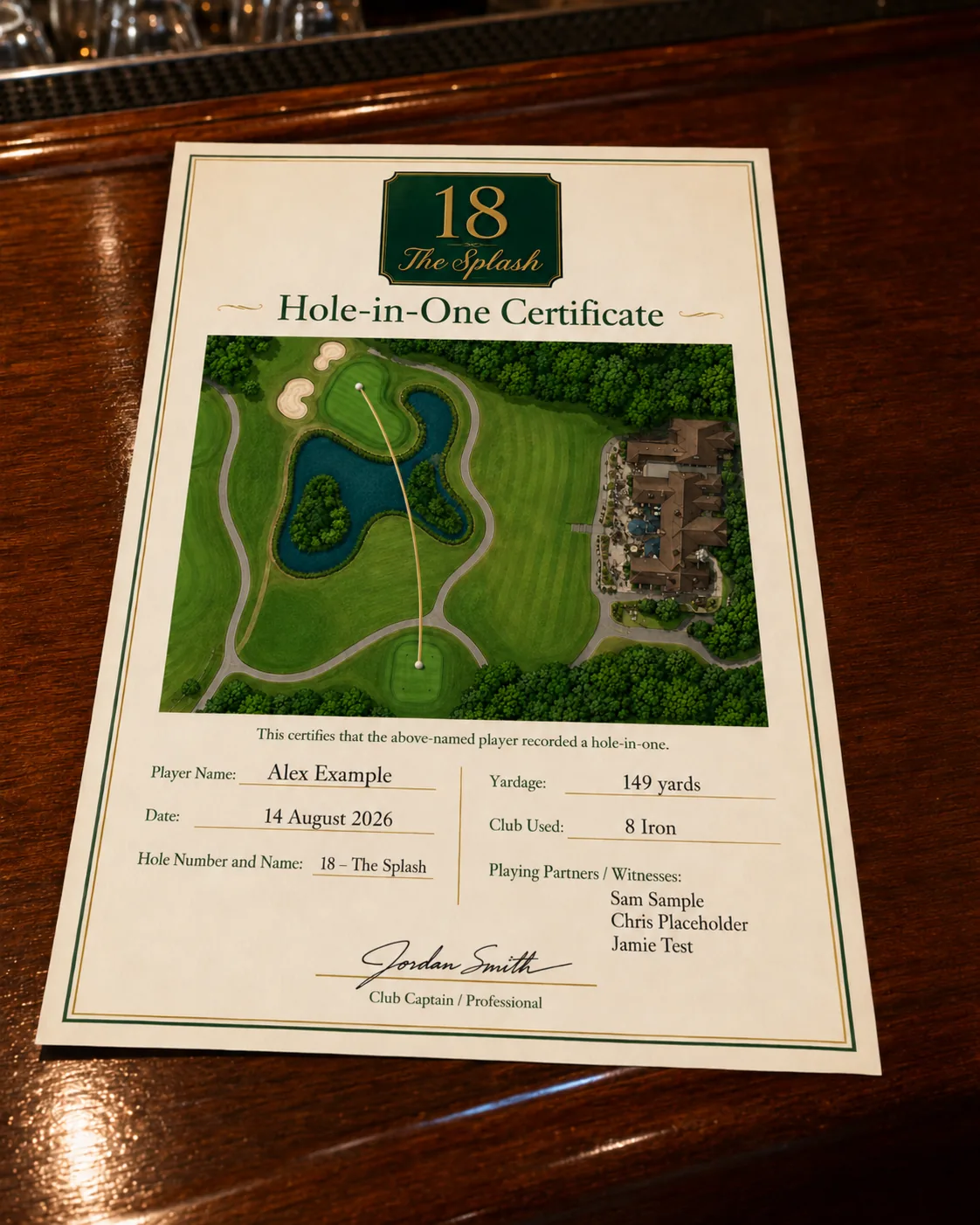 Printed hole-in-one certificate for the 18th resting on a polished bar top, with an aerial view of the hole tracing the ball flight from tee to pin, and ruled lines for the player's name, date, yardage, club used and witnesses.